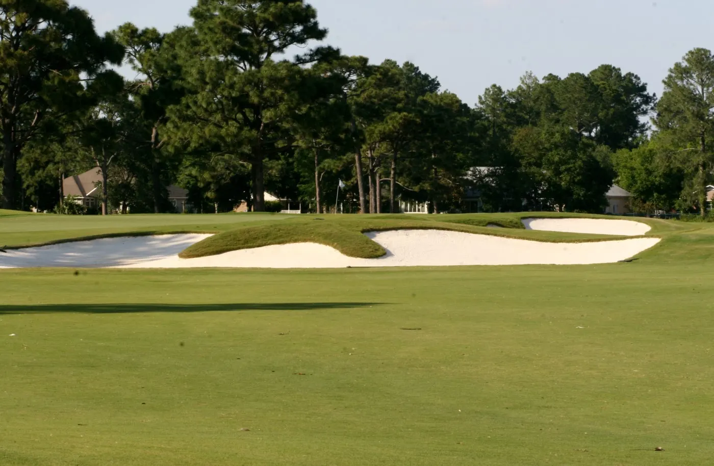 Fairway running up to a green set behind wide white sand bunkers at Gulf Shores Golf Club